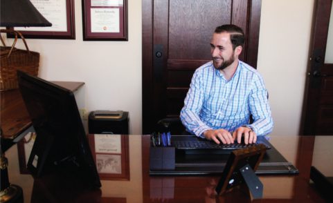 Indianapolis Adoption Lawyer Bryan D. Stoffel typing on computer